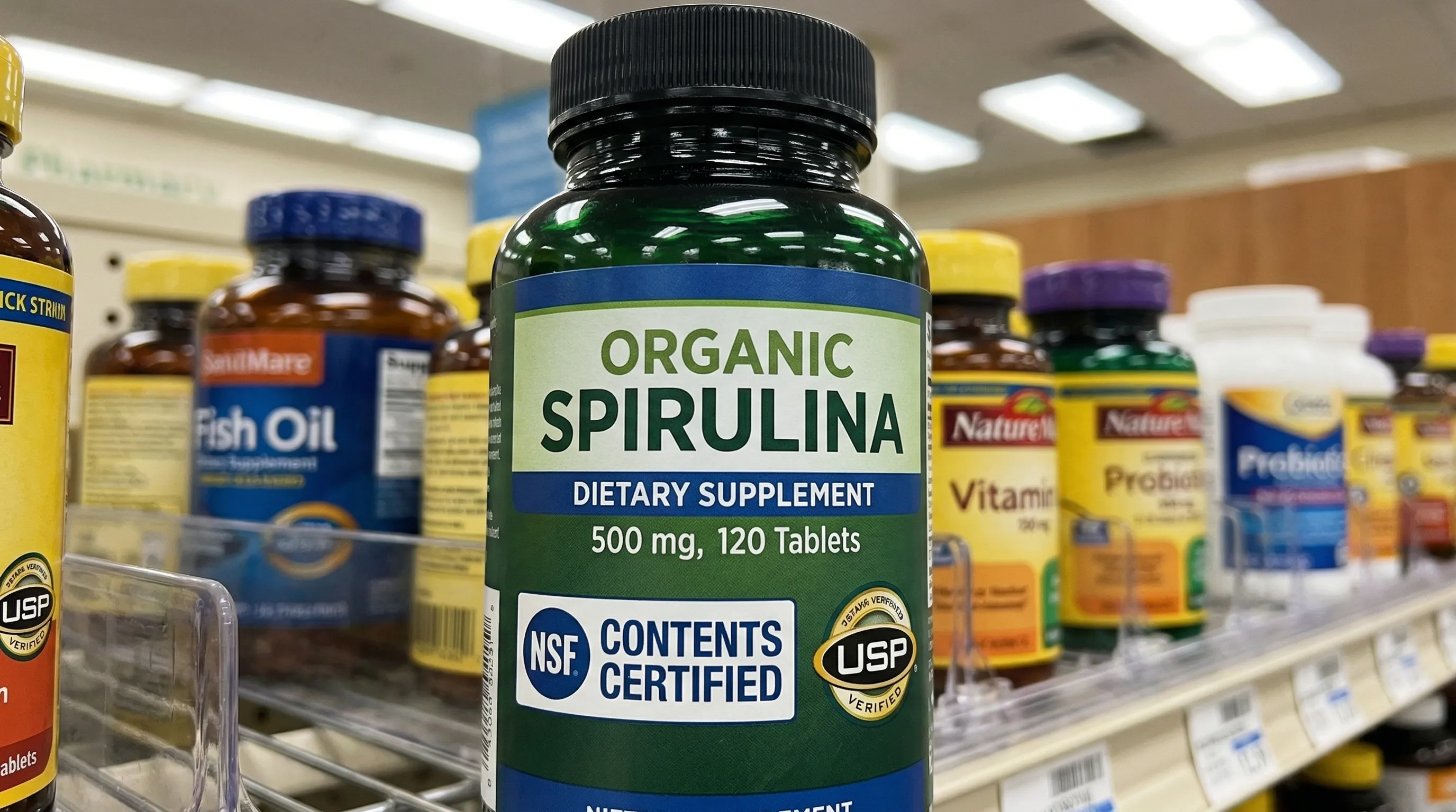 Close-up of a spirulina supplement label showing third-party testing and heavy metal certification badges